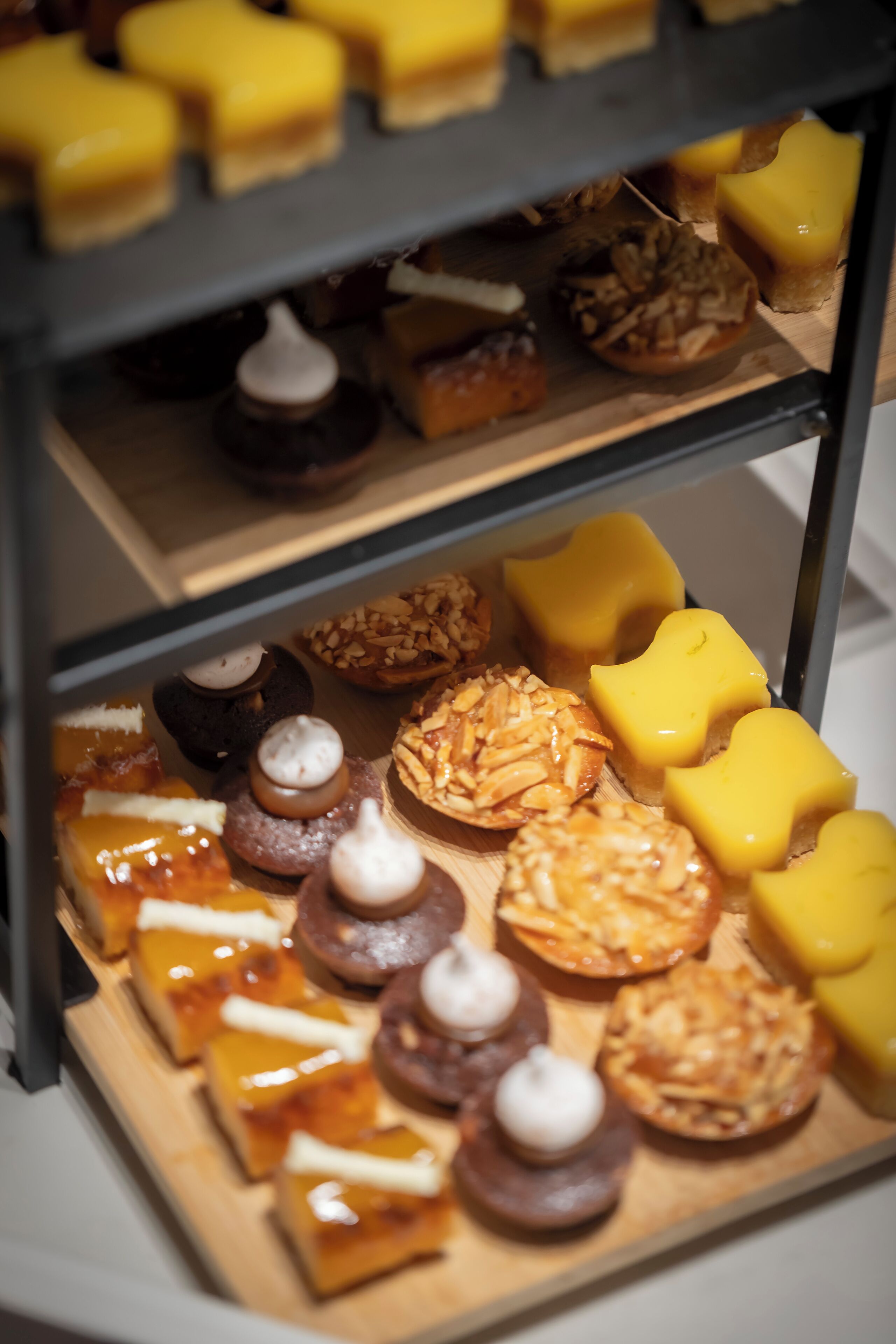 A display case with various pastries and desserts.
