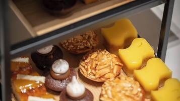 A display case with various pastries and desserts.