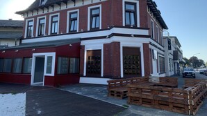 A two-story building with a 'VIVA' sign, large windows, and a wooden deck area. - Quickborner Hof (Quickborn)