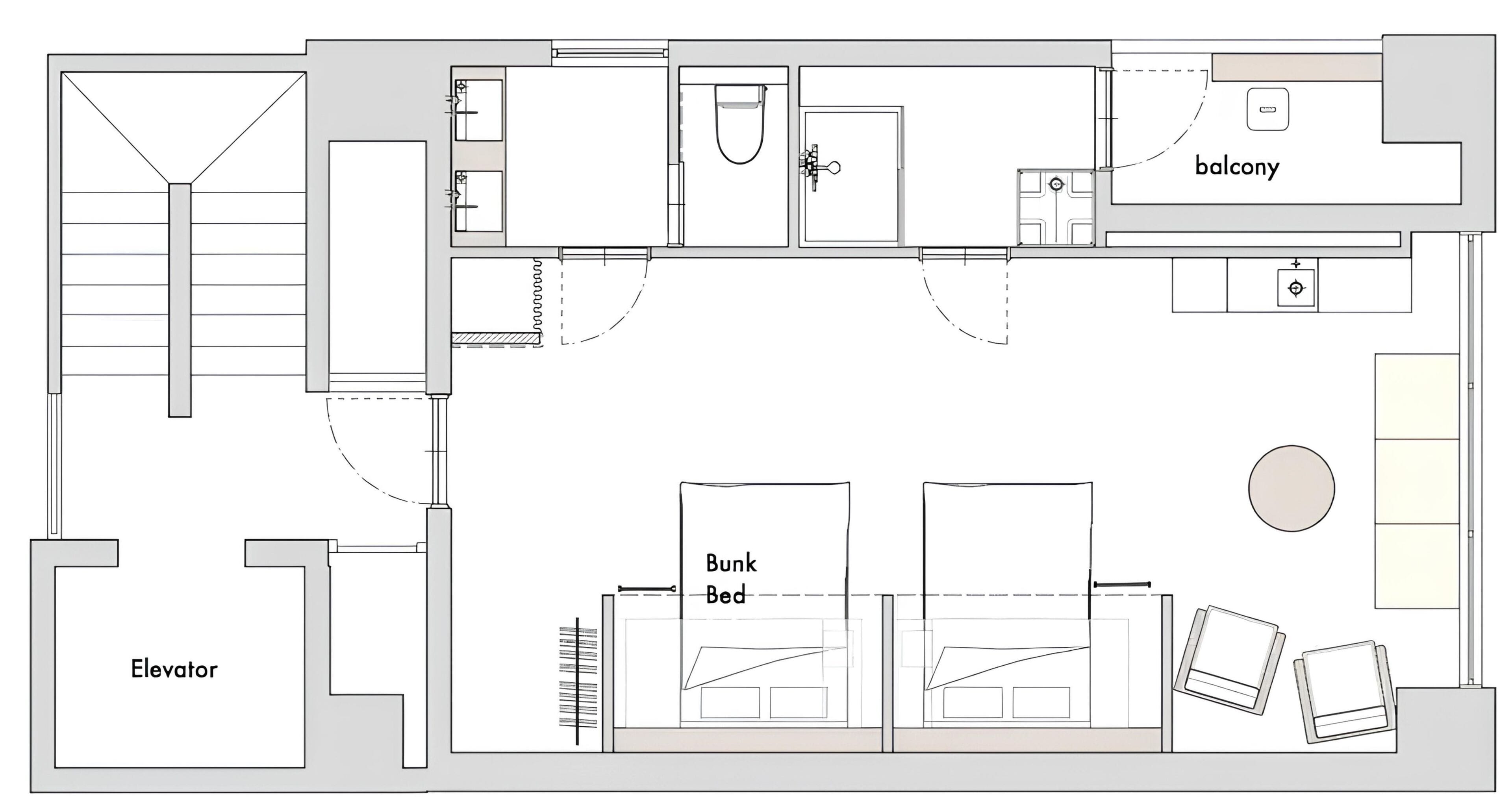 A hotel floor plan with an elevator, bunk beds, a balcony, and a bathroom.