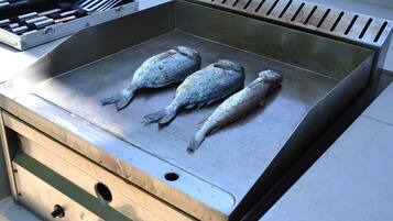 A grill with three fish on it.