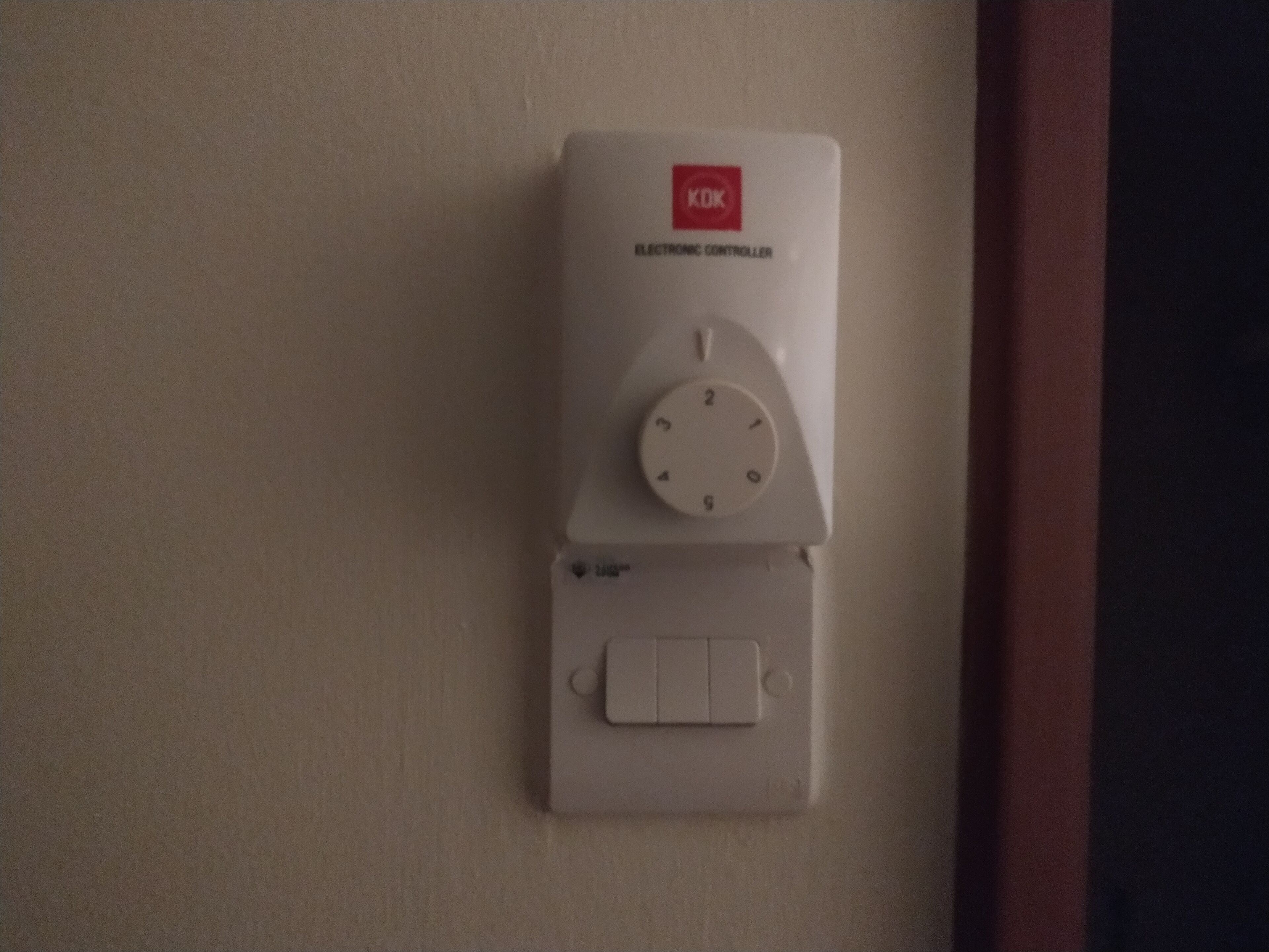 A KOK electronic controller with a dial and a switch.