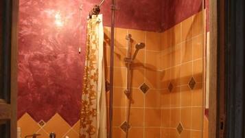 A small bathroom with a shower, a toilet, and a sink.