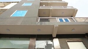 A multi-story building with a flat roof, several windows, and a ventilation system. - Hotel Aerocity Golden (New Delhi)