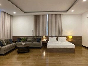 Executive Quadruple Room | Living room | Flat-screen TV