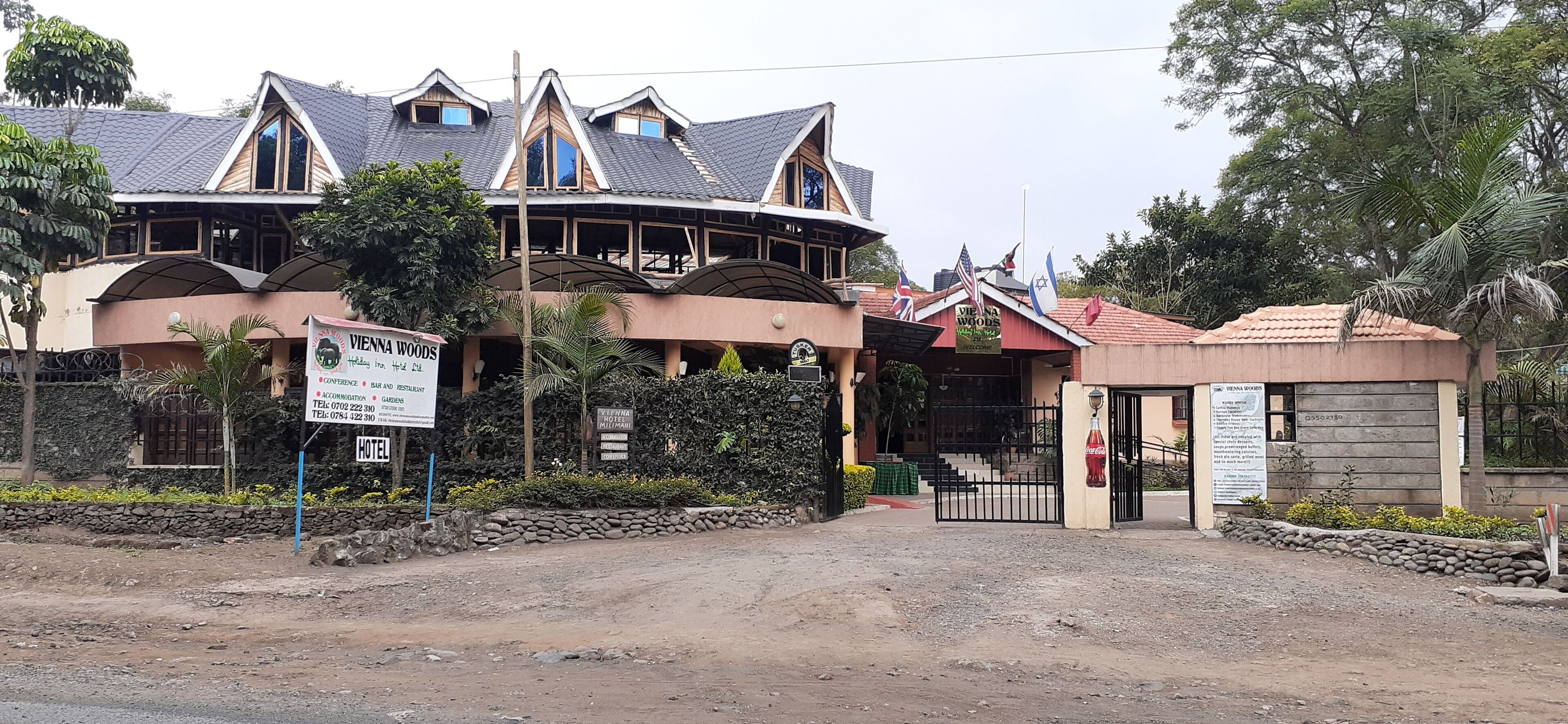 A hotel with a unique architectural design, featuring multiple levels and a prominent entrance gate.
