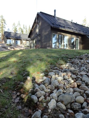 A modern house with a stone pathway leading to the entrance.