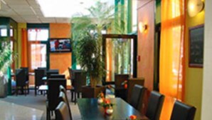 A restaurant with a long table, chairs, and a potted plant. - Hotel beim Hirschen (Merzhausen)