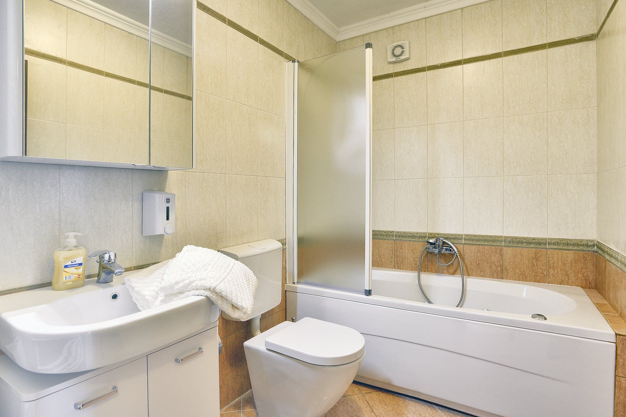 A bathroom with a sink, toilet, and bathtub.