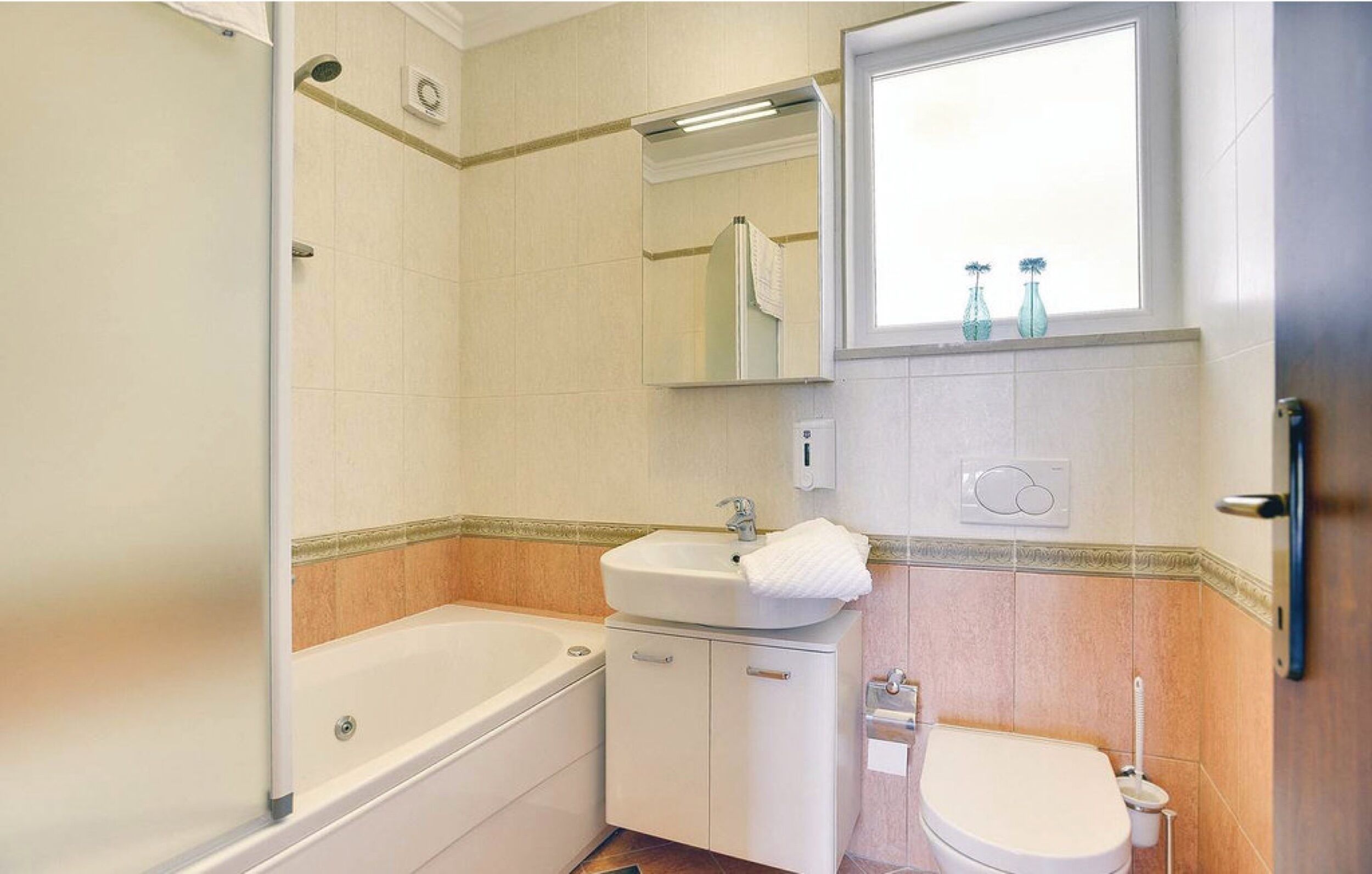 A bathroom with a bathtub, a sink, and a toilet.