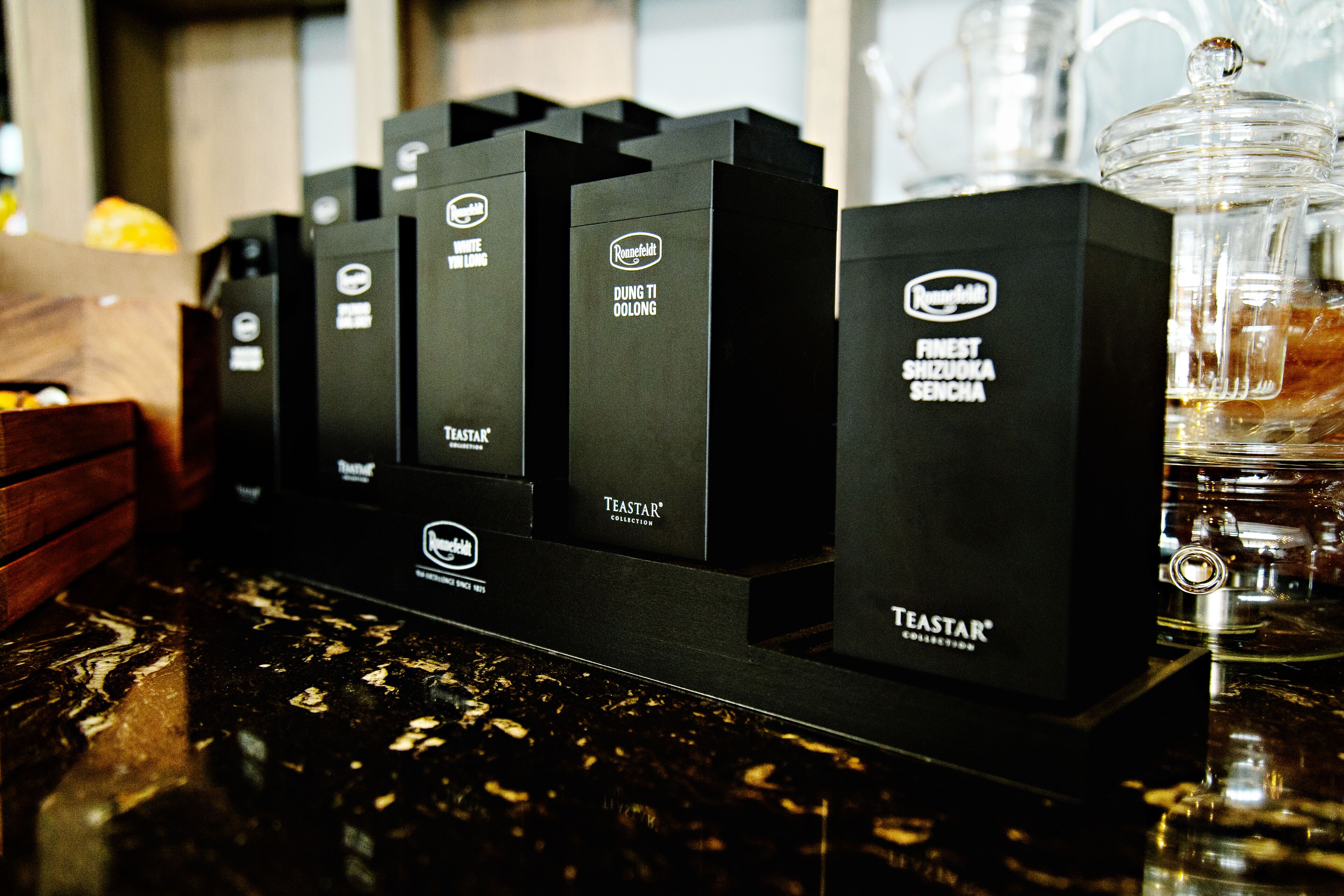 A display of black boxes with the Teestar logo, arranged on a counter.