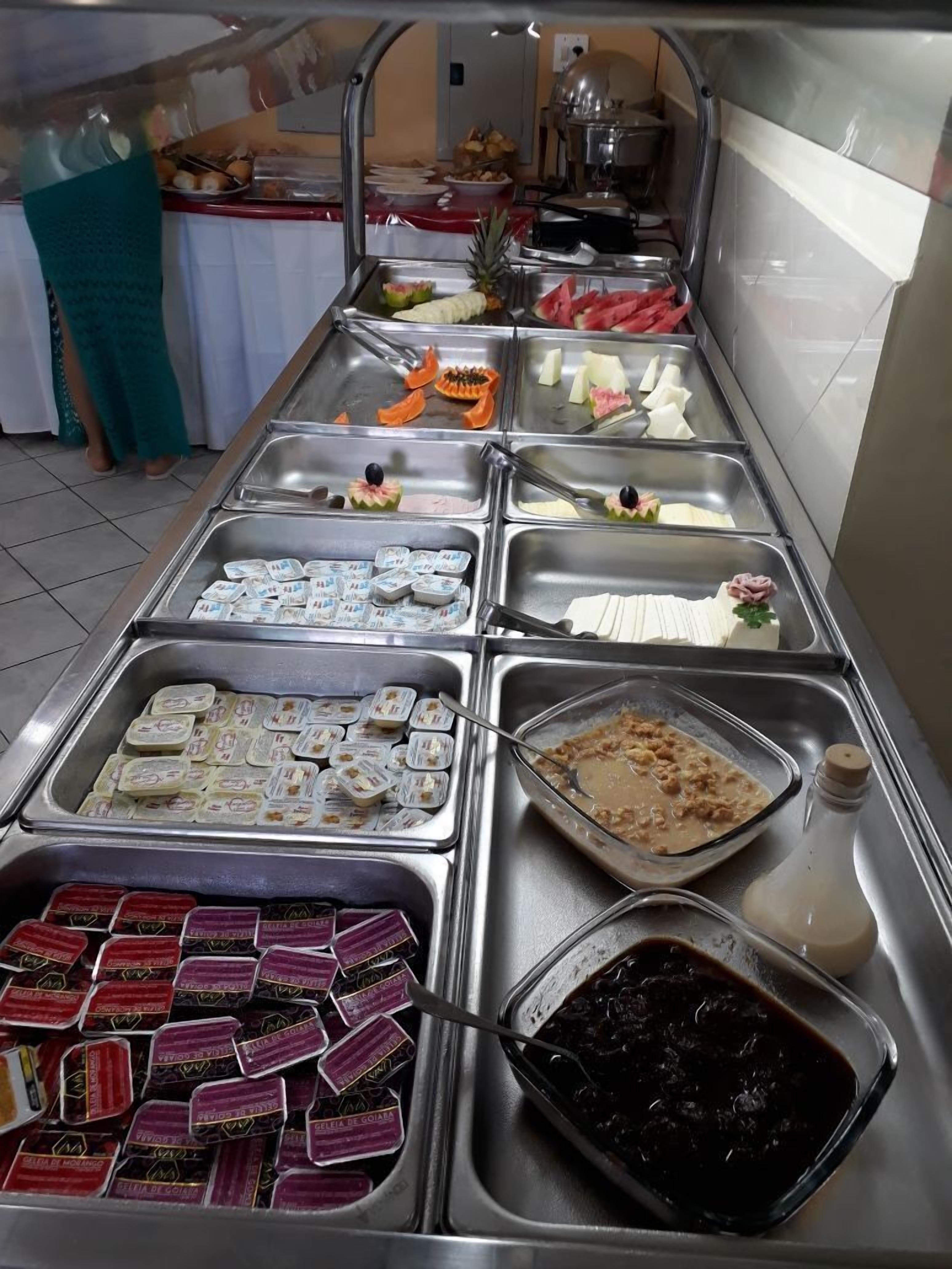 A buffet with various food items and condiments.