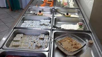 A buffet with various food items and condiments.