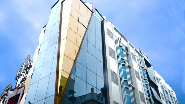 A modern building with a glass facade and a geometric design. - Hotel Shreesh Kolkata (Kolkata)