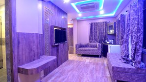A modern bathroom with a wooden vanity, a mirror, and a shower area. - Hotel Shreesh Kolkata (Kolkata)