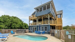 A two-story house with a pool, deck chairs, and a table. - Climate Change - Duck, Sea Tern, Oceanside, 280 Yds to Beach, Pool, Hot Tub, Pets OK (Duck)