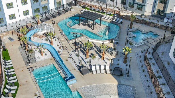 A multi-level swimming pool complex with various pool shapes and lounge areas.