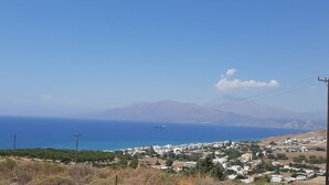 A coastal town with a clear view of the sea and mountains in the distance. - Kalamaki Sight Irene's (Faistos)