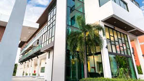 A modern building with multiple floors, large windows, and a balcony. - The Thames Pool Access Resort SHA+ (Chalong)