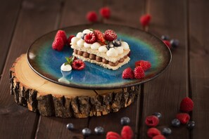 A dessert on a wooden board with a rustic background.