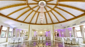 A large hall with a high wooden ceiling and a central chandelier. Tables are arranged in rows with white tablecloths and chairs. - Lesna Perla - Restaurant and Hotel (Rudziniec)