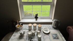 A room with a view of a green field through a large arched window. - Drum Manor (Hillsborough)