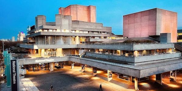 The National Theatre building showcases a striking modernist design with a multi-level structure and geometric form.