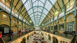 A spacious indoor market with a high glass ceiling, multiple levels, and a variety of shops and seating areas. - P1E Double Room Private Shower air con wifi (London)