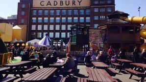 A building with the sign 'CADBURY' and a crowd of people outside. - Birmingham Garnet, 3 Bedroom Apartment (Birmingham)
