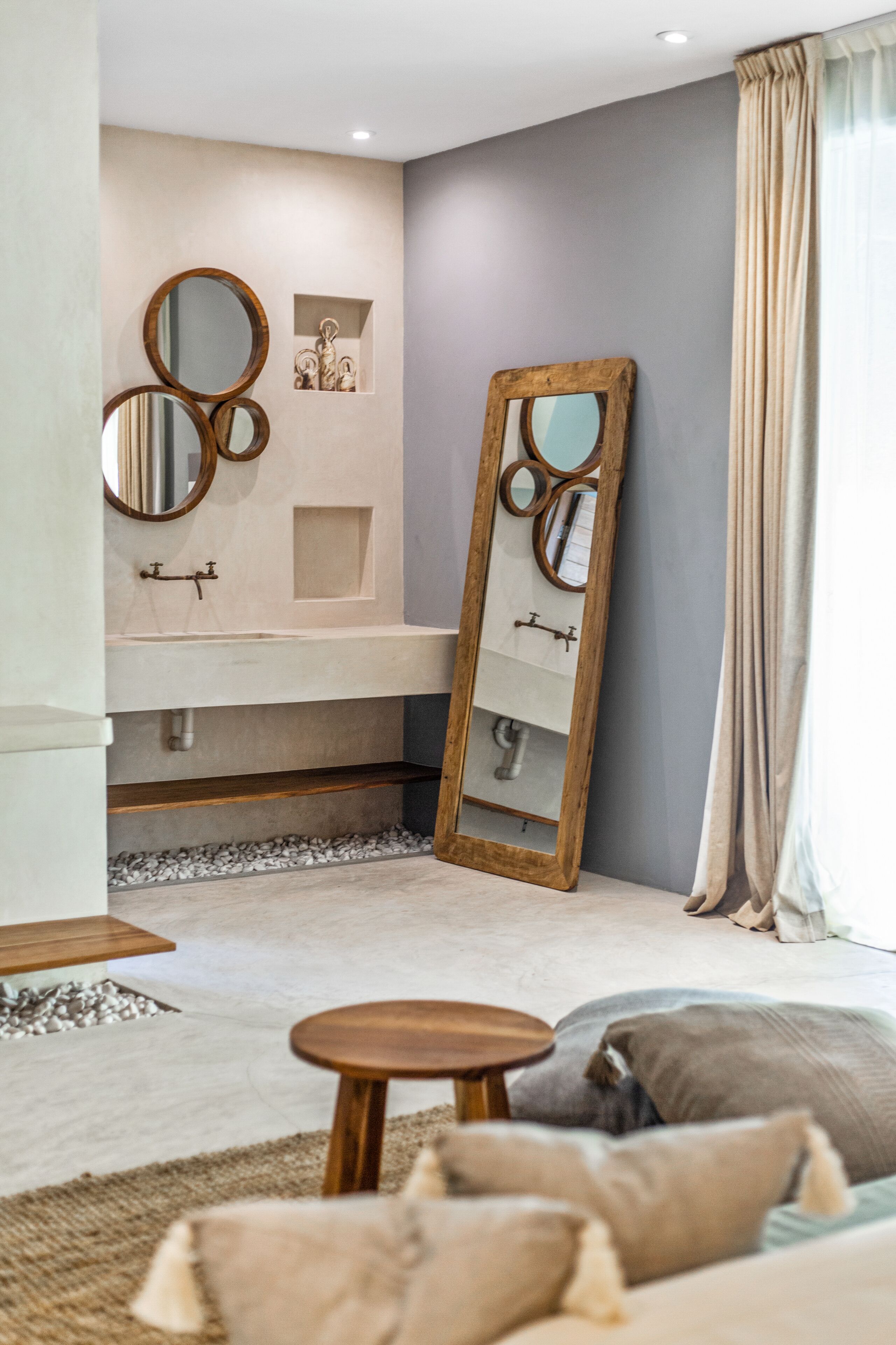 A modern bathroom with a large mirror, a sink, and a vanity.