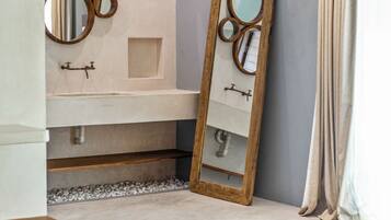 A modern bathroom with a large mirror, a sink, and a vanity.