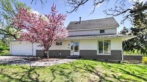 A single-story house with a garage, a covered porch, and a well-maintained lawn.