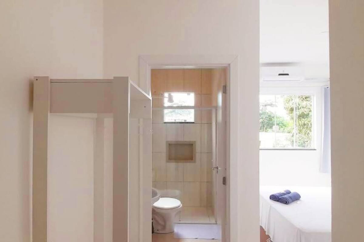 A bathroom with a toilet, a sink, and a shower area.