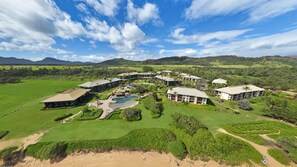 A resort with multiple buildings, a swimming pool, and lush green surroundings. - 4 Star Beach Front Hotel Resort, Lanai Ocean View, one minute walk to the beach (Lihue)