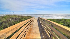 A wooden boardwalk leading to a beach with ocean views. - Ocean-Pool Views From 2 Balconies | MP315 (Port Aransas)