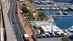 A coastal road with a marina in the background. - 2 ROOMS GREAT TERRACE ROOFTOP FULL CITY CENTER (Nice)