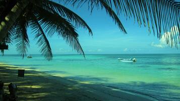 On the beach, white sand, free beach cabanas, sun loungers
