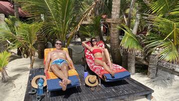 On the beach, white sand, free beach cabanas, sun loungers