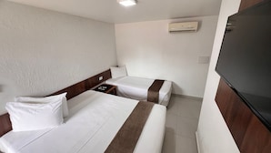 A hotel room with two beds, a flat-screen TV, and an air conditioning unit. - Rede Andrade Estrela Dalva Praia Hotel (Porto Seguro)