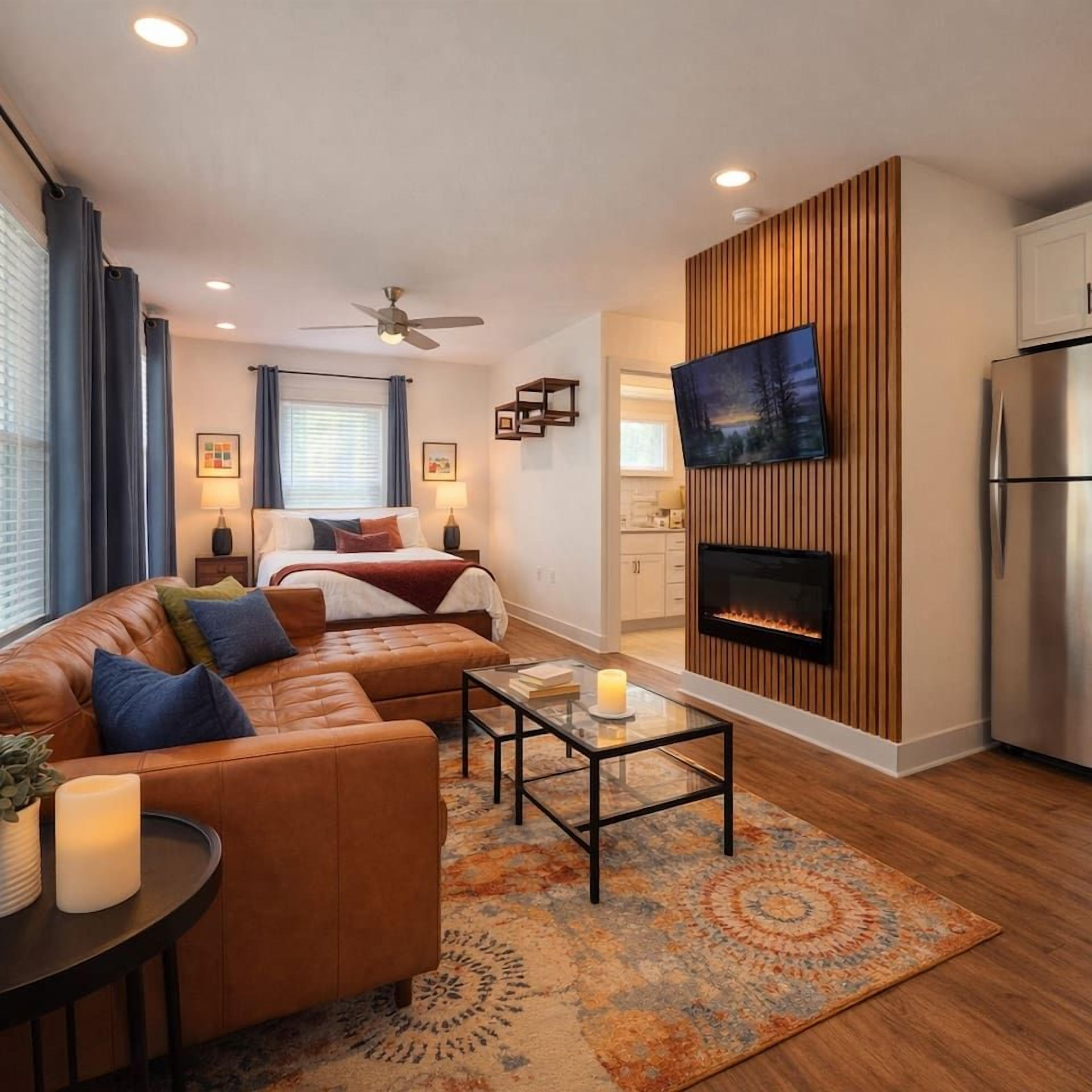 A modern living room with a sofa, coffee table, and a fireplace.