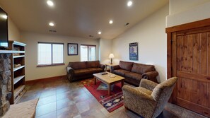 Relax in this inviting living room with a sofa, armchair, and coffee table.