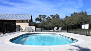 A swimming pool with lounge chairs, a covered area, and a building with a metal roof. - Beautiful 5/5.5 home on 5 acres w/private pool. River access 2 m. away (Rio Frio)