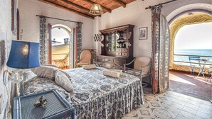 A bedroom with a bed, dresser, and a view of the sea. - Cozy home in Tarquinia (VT) with WiFi (Tarquinia (VT))