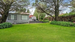 Welcome to a charming home with a well-manicured lawn and a two-story residence featuring a natural entrance.
