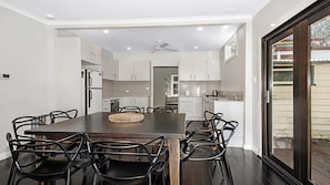 Enjoy meals in the kitchen with an oven and refrigerator, and dine at the large table surrounded by comfortable chairs.