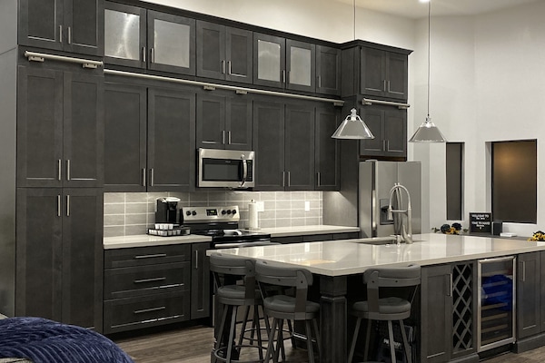 The massive island features a wine fridge and rack.
