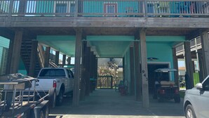 A two-story building with a covered entrance and a balcony. - Feelin’ Tip Sea - *Sleeps 10* Walking Distance to the beach! (Crystal Beach)