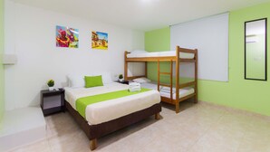 A hotel room with a single bed, a bunk bed, a nightstand with a lamp, a small table with a plant, and two paintings on the wall. - Hotel Avexi Suites By Geh Suites (Cartagena)