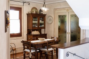 Enjoy meals in this dining area with a table, chairs, and a cabinet.