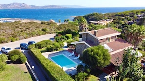 Enjoy a pool surrounded by lush greenery and a stunning sea view.